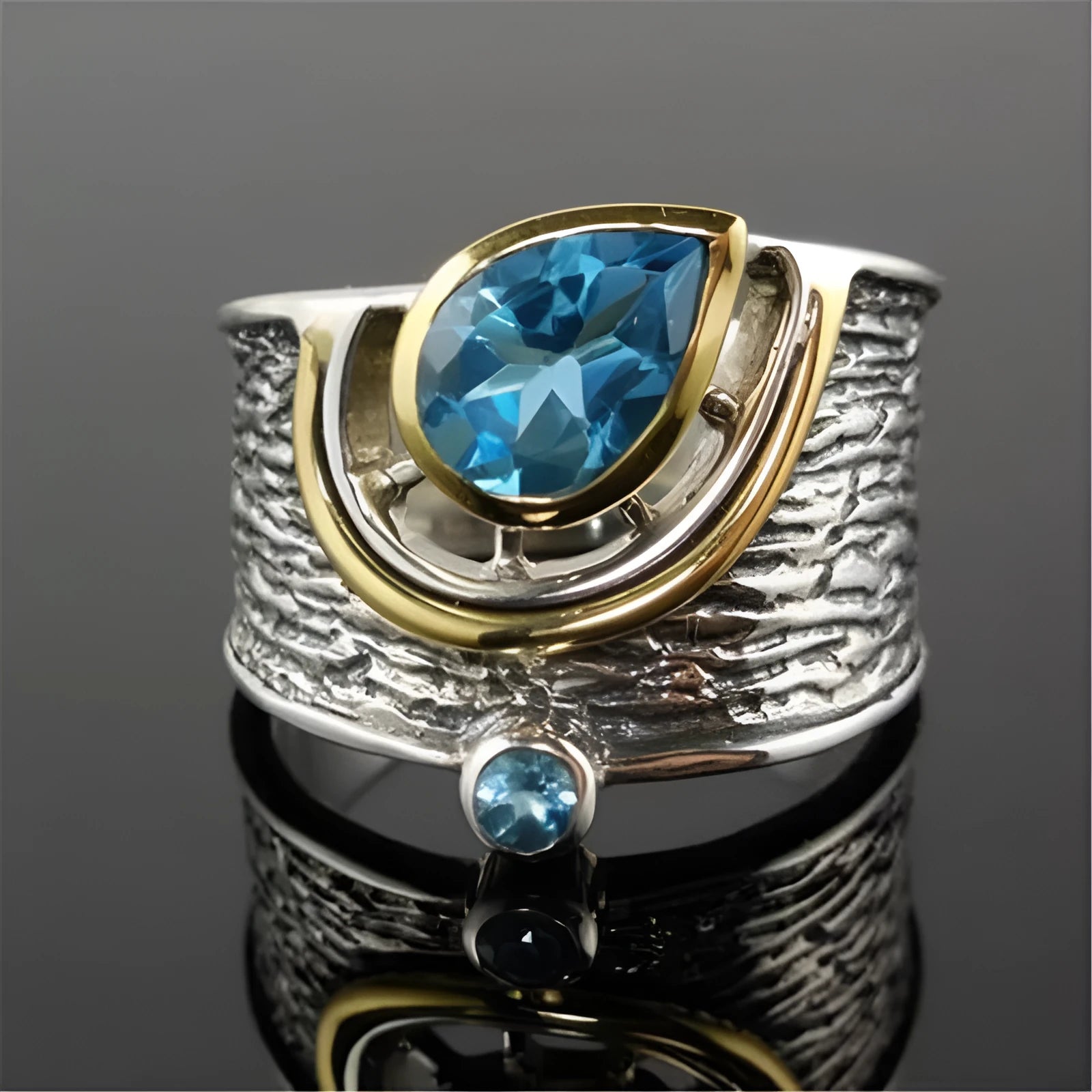 Blue zircon drop shape ring with Chinese-inspired design in alloy setting