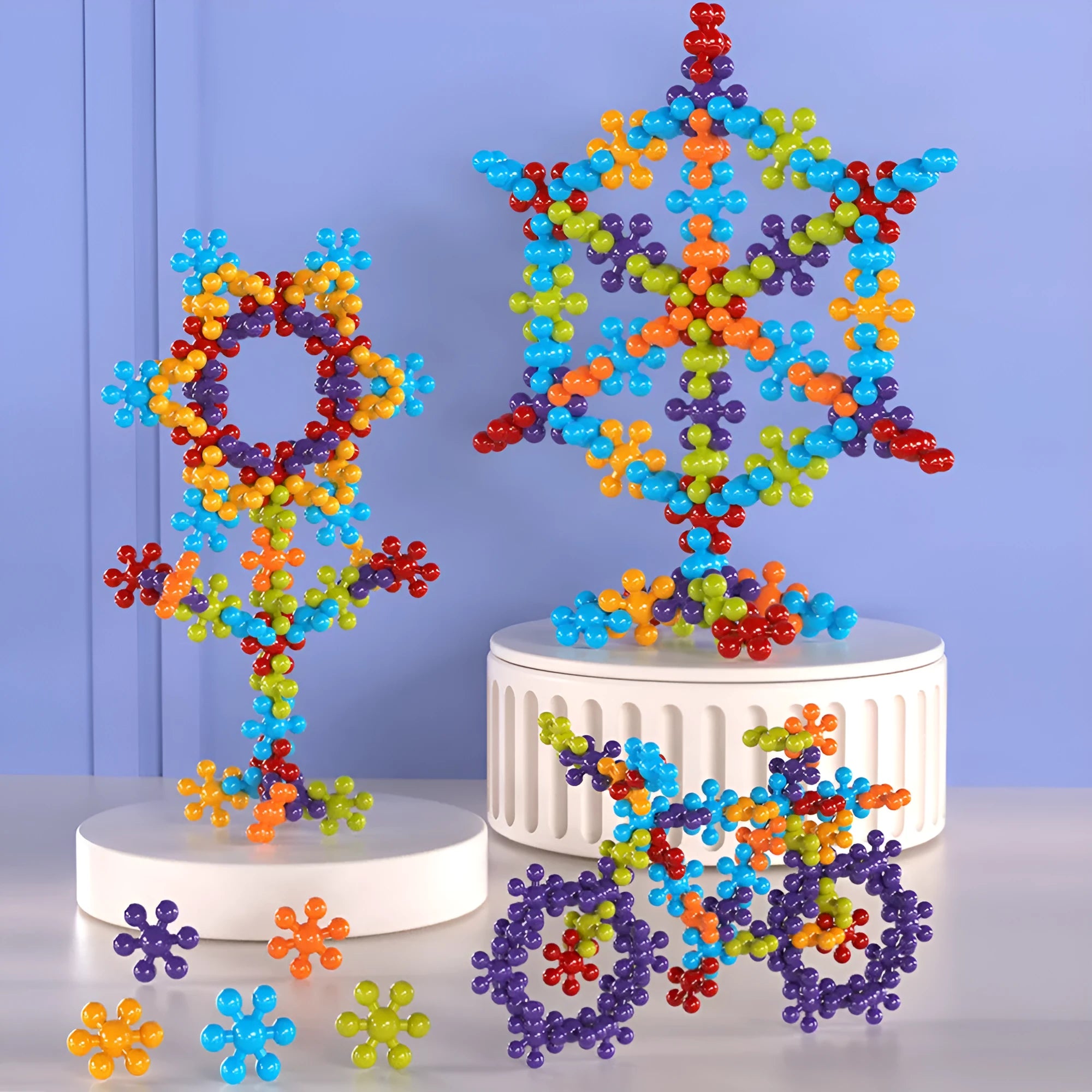 DIY plum blossom building blocks arranged in flower shape with rainbow colour pieces on white background