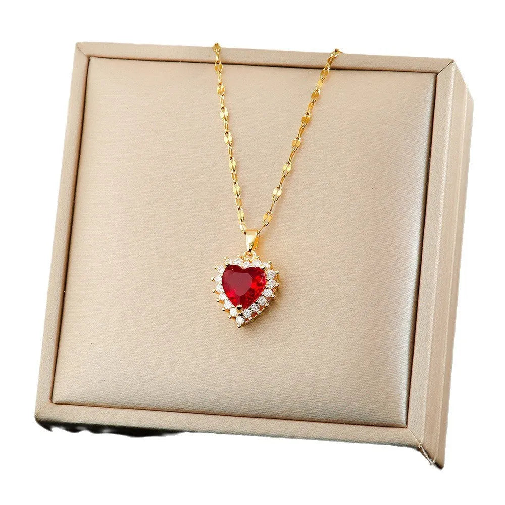Gold red titanium steel jewellery suit with heart and flower pendant necklace, matching ear studs, and ring.