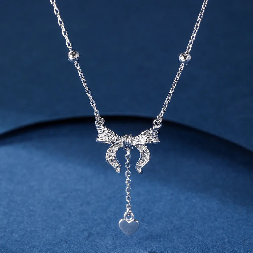 Silver butterfly heart pendant necklace with bow detail on O-ring chain