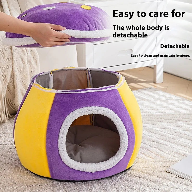 Purple mushroom-shaped plush cat nest with a detachable blanket, shown on a wooden floor.
