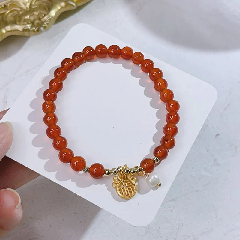 Red agate bracelet for women with dragon motifs and traditional Chinese lucky charms