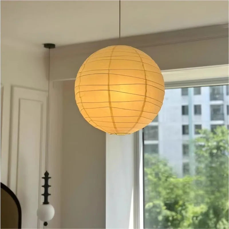 Japanese style spherical rice paper ball chandelier pendant light with warm glow.