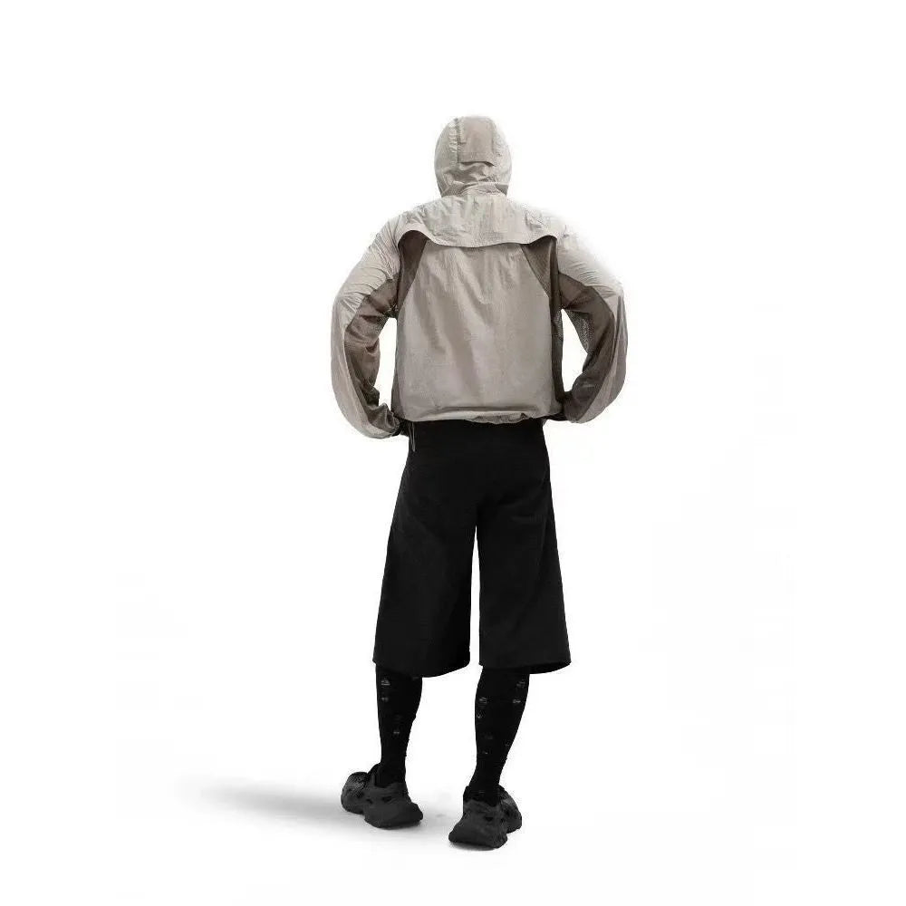 Nylon sun protective top with mesh stitching in desert brown, light grey, red and blue colours.
