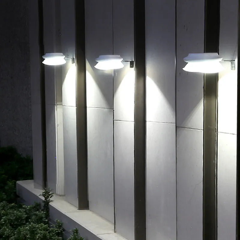 Solar outdoor wall lamp in black or white plastic housing with integrated solar panel and 9 LEDs.