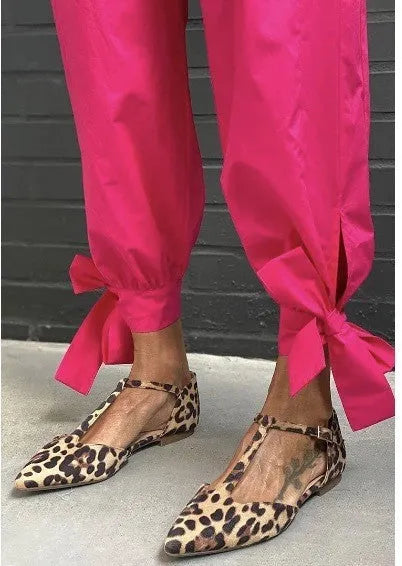 Leopard print women's pumps with a pointed toe and a low chunky heel on a rubber sole.