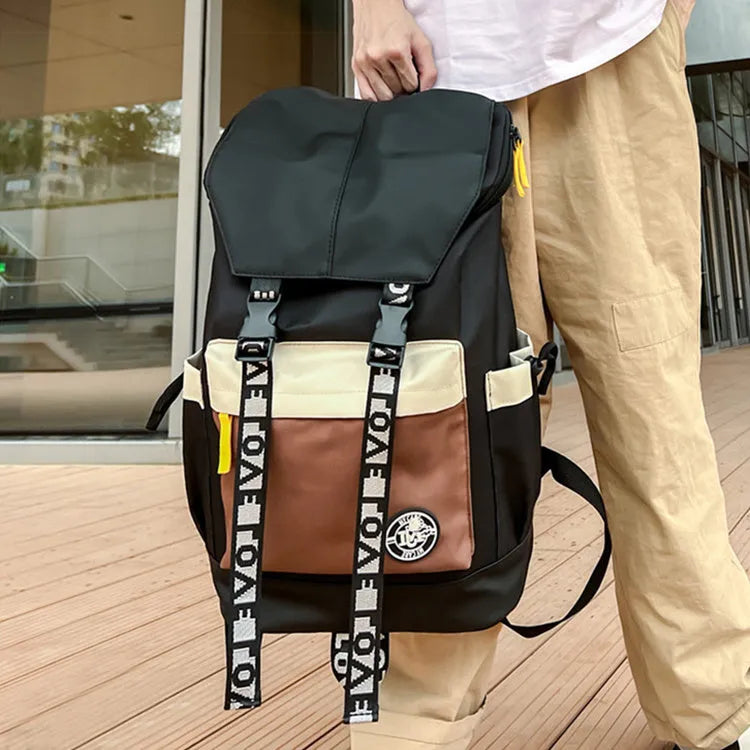 Oxford cloth backpack in black showing handheld strap and shoulder straps
