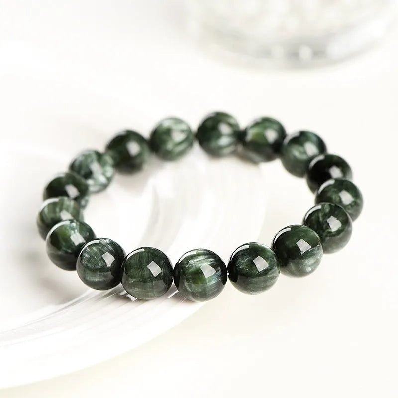 Green Dragon Crystal bracelet with round 8-9mm beads on a wrist.