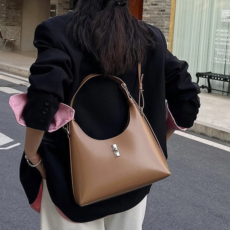 Women's genuine leather dumpling-shaped crossbody shoulder bag in apricot colour with a sandwich pocket.