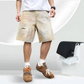Men's light blue washed denim shorts with ripped details and a straight-leg cut