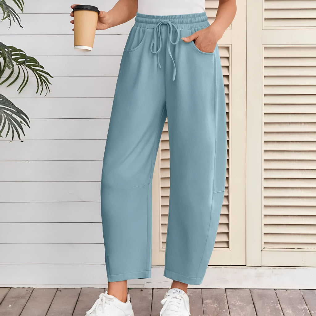 Women's loose cropped sweatpants with elastic waist and drawstring pockets in street fashion style
