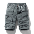 Men's army green cotton shorts with multiple zipper pockets and a Korean style design on a hanger.