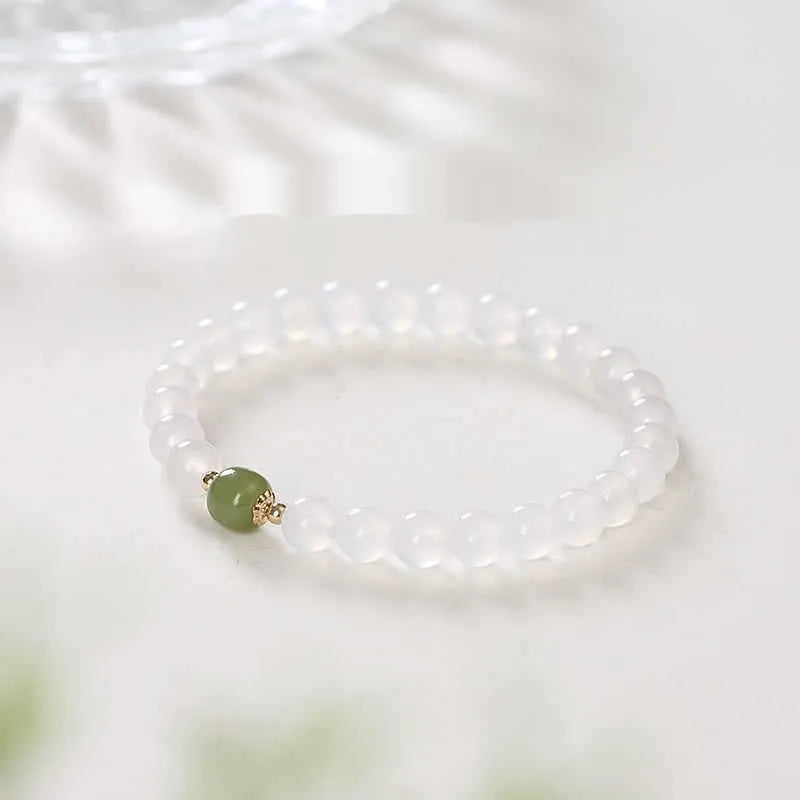 Handmade white agate crystal bracelet with cinnabar inlay showing 6mm and 8mm bead size options