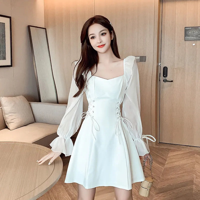 White long sleeve chiffon patchwork dress on a model, showing waist-slimming design and long skirt.