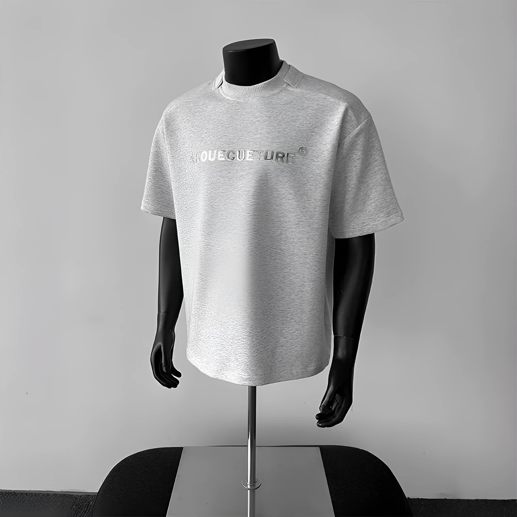 Man wearing a loose fit black short sleeve cotton T-shirt with a white graphic letter print.