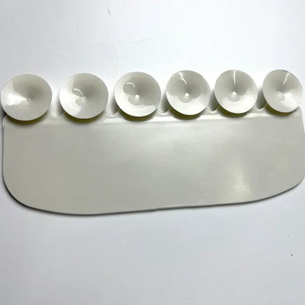 White PVC urine blocking board for children's toilet training placed on toilet