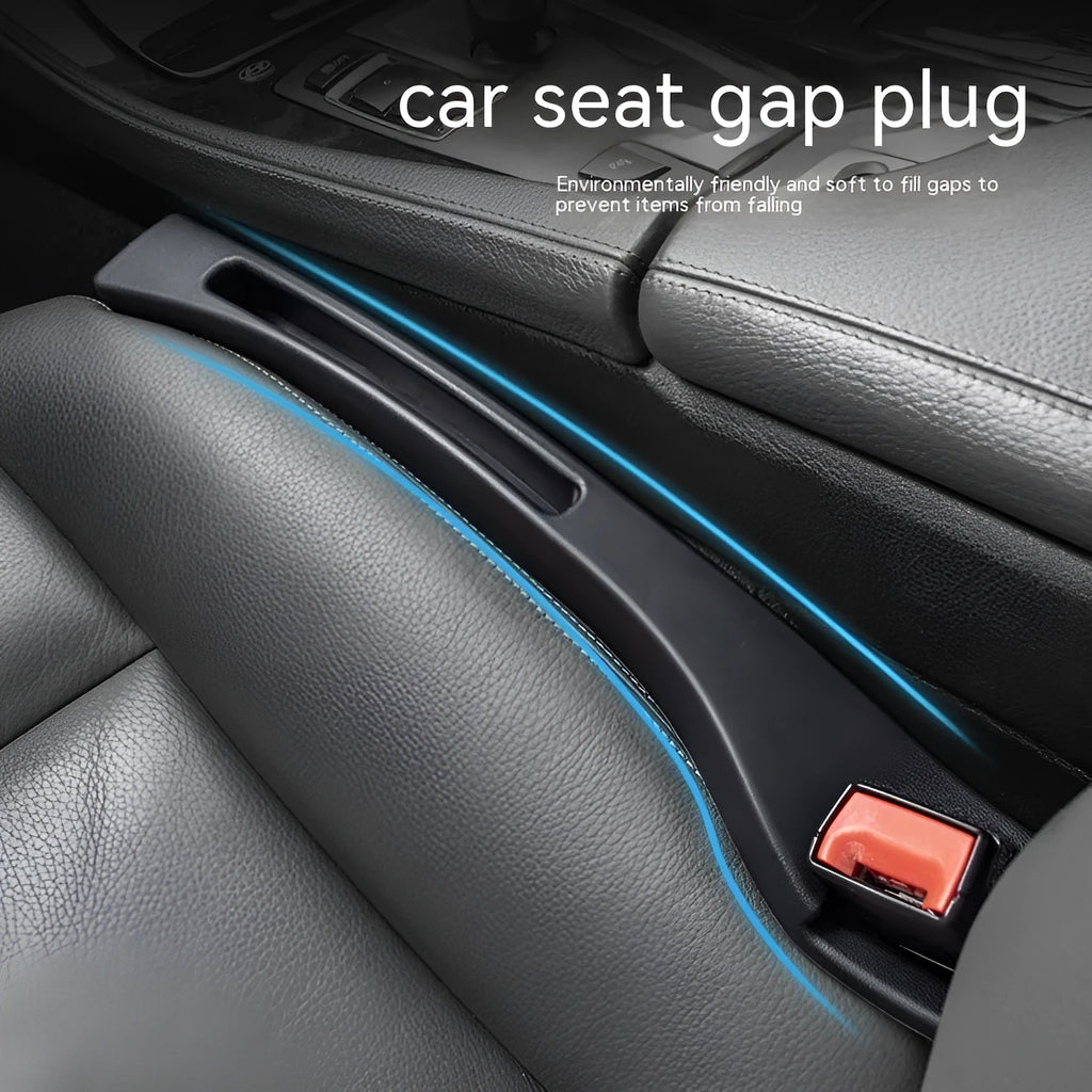 Black plastic car seat gap storage box with handle positioned between vehicle seats