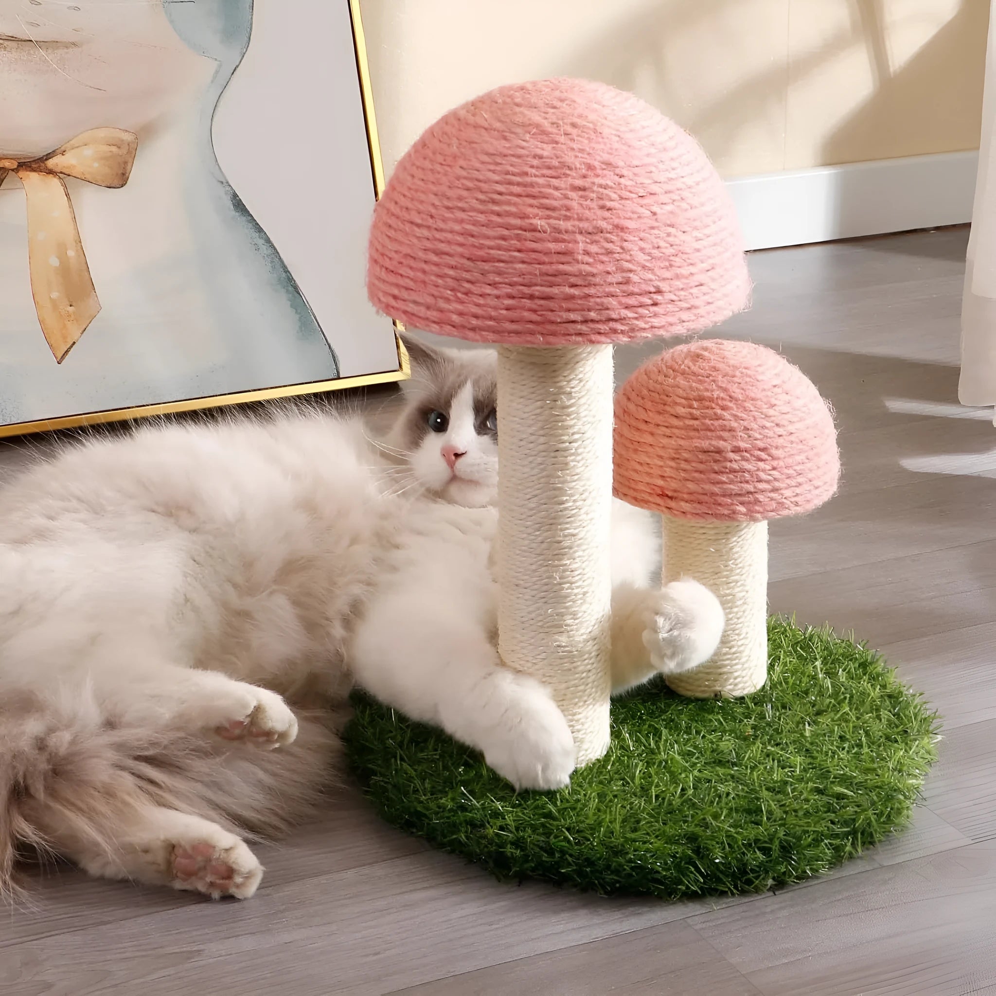 Pink mushroom-shaped cat scratching post with natural sisal caps on a sturdy base for small cats.