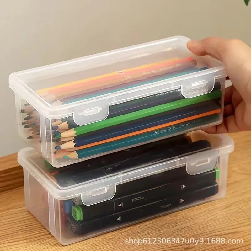 Transparent plastic stationery storage box containing pencils and drawing supplies