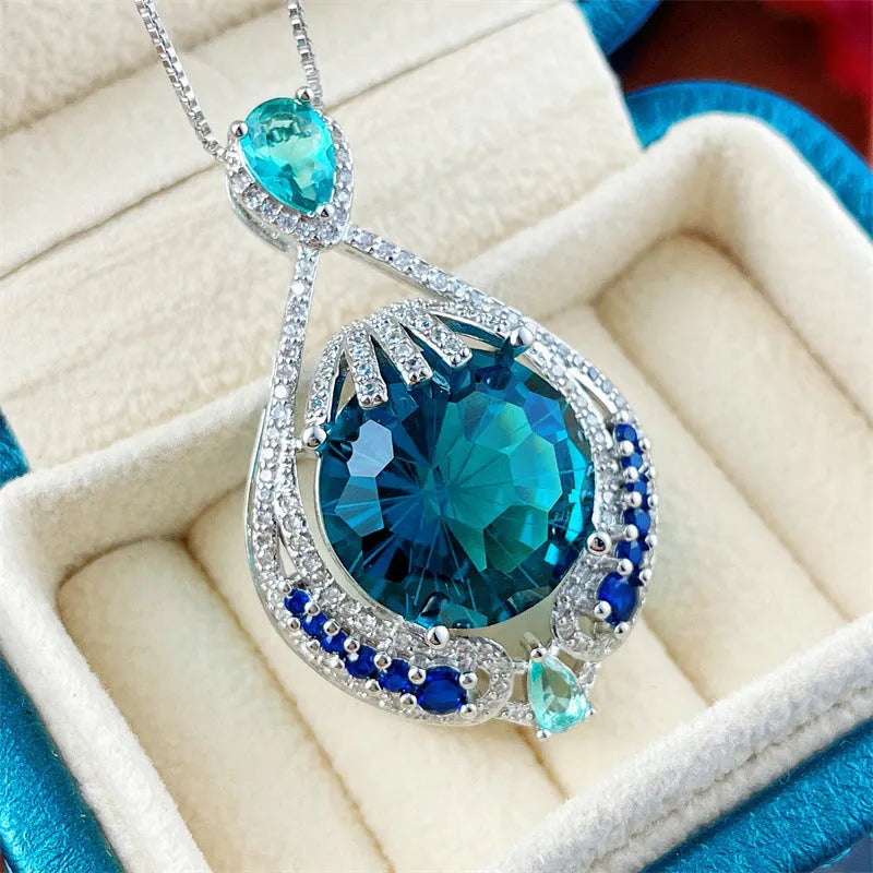 Women's bright blue crystal necklace with geometric fireworks-cut pendant on water wave chain
