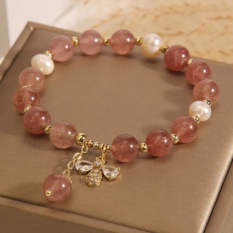Freshwater pearl and strawberry quartz bracelet with zircon accents on wrist