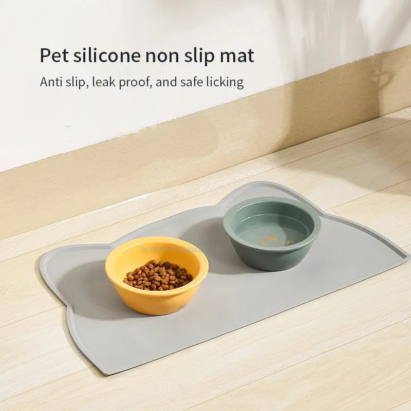 Blue silicone pet feeding mat with raised border for dog and cat food bowls