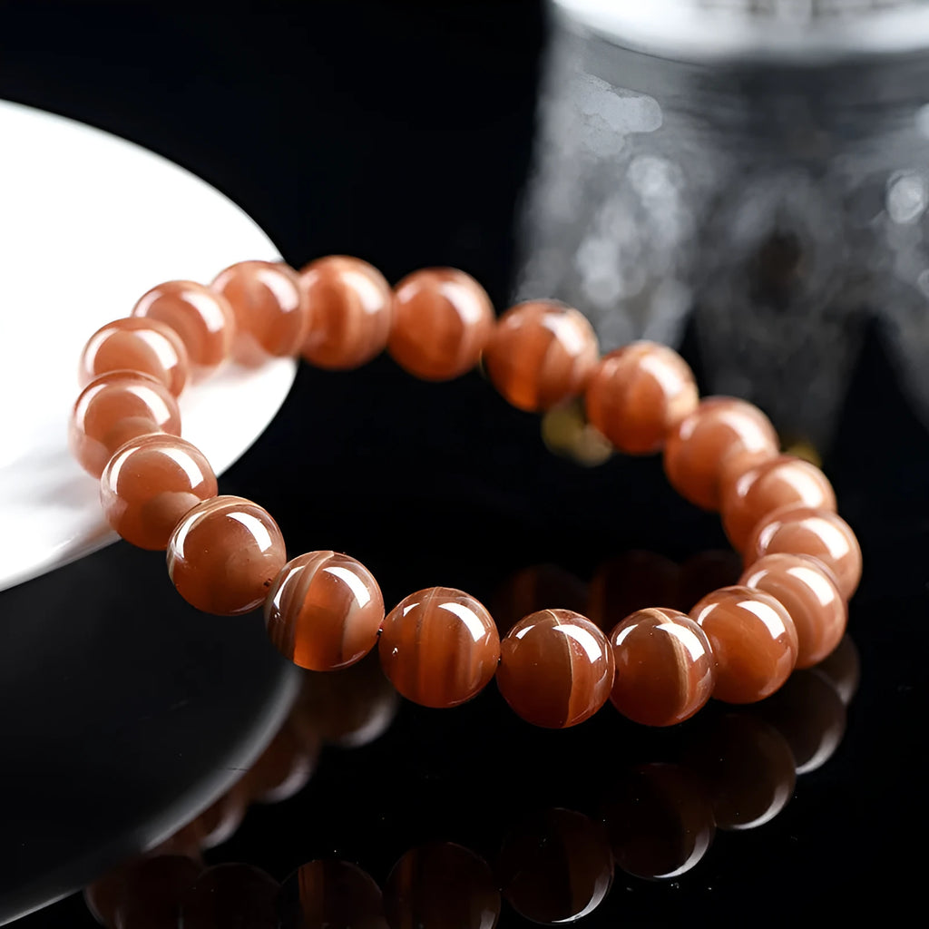 Natural Old Mine Rhodochrosite round beads bracelet from Peru showing manganese spar mineral colour