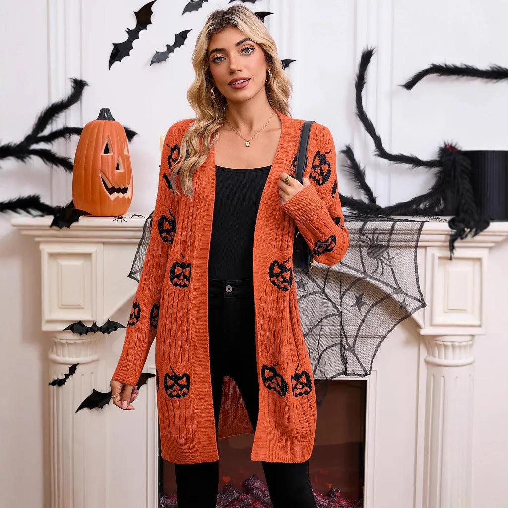 Women's black Halloween cardigan with orange pumpkin head jacquard knit pattern, shown open.