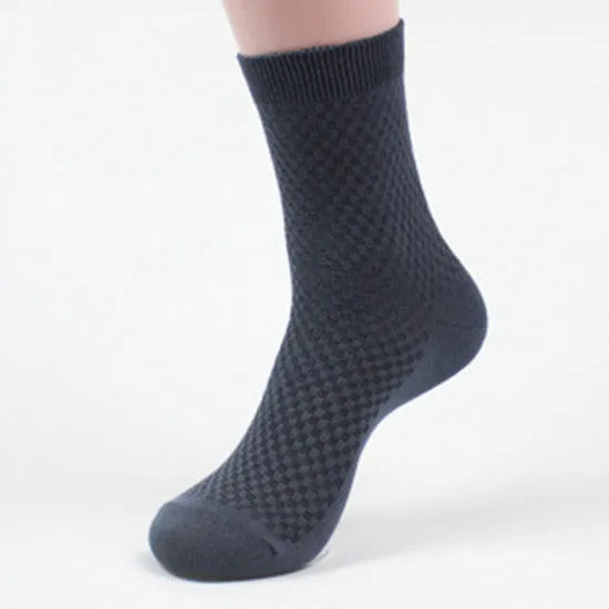 Men's bamboo fibre business socks in small square pattern, shown in classic colours on a grey background.