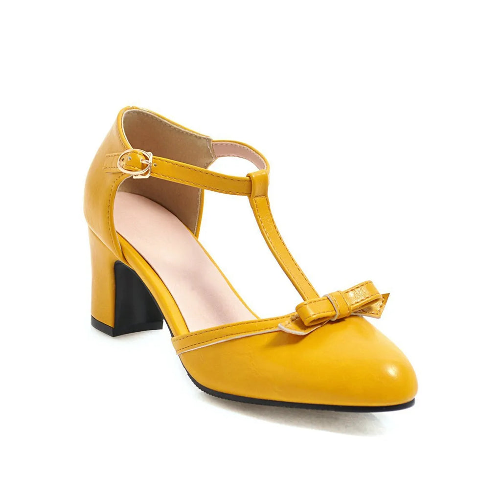 Women's apricot coloured chunky heel sandals with a bow decoration and buckle strap.
