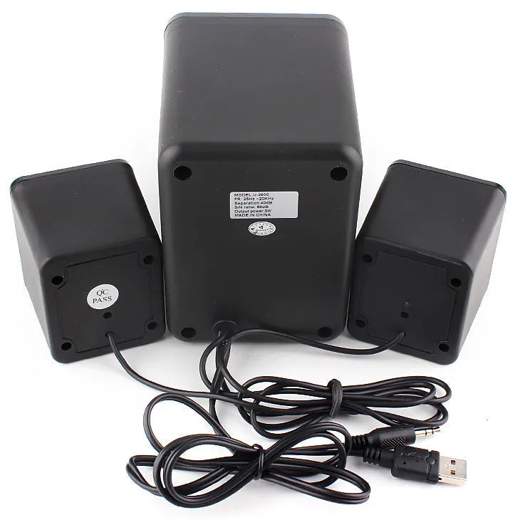 Green U-2600 2.1 USB computer speaker with colourful LED lights on a desktop.