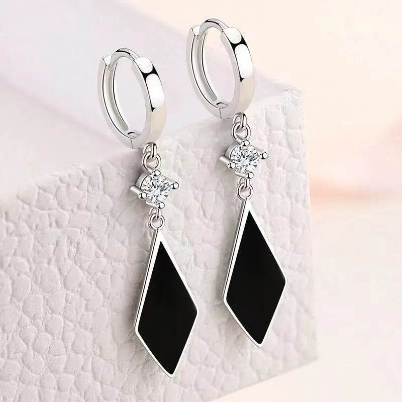 Silver geometric diamond-shaped clip-on fashion earrings with a vintage diamond finish.