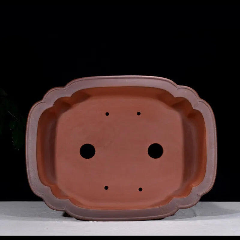 Large antique-finish purple clay flowerpot with raised tree stump and floral design.