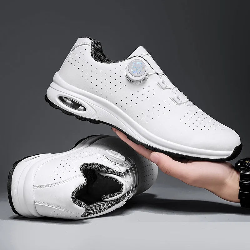 Black and white low-top casual tennis shoes with mesh upper, cross shoulder straps, and flat composite sole.
