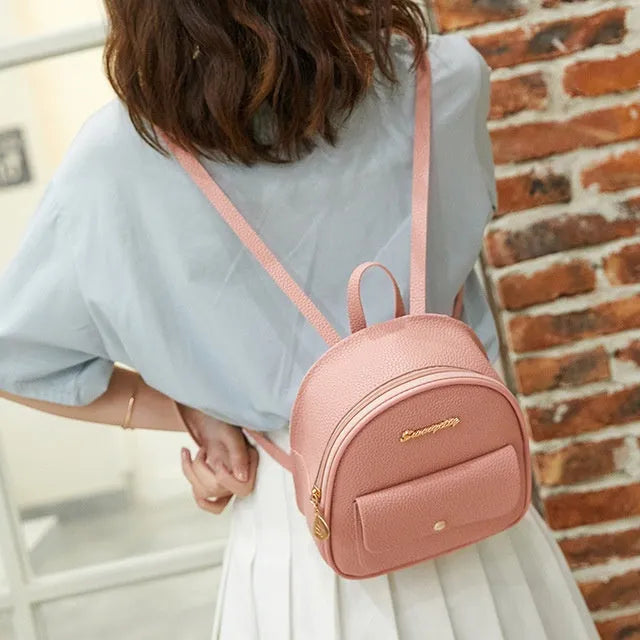 Small PU leather shoulder backpack in black colour showing zipper closure and compact dimensions