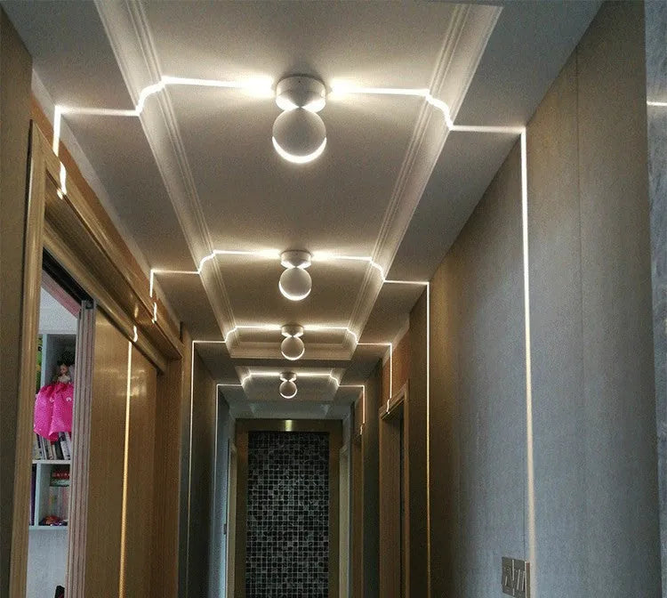 Modern aluminium corridor wall spotlight bar with glass lens and colour-changing LED light options.