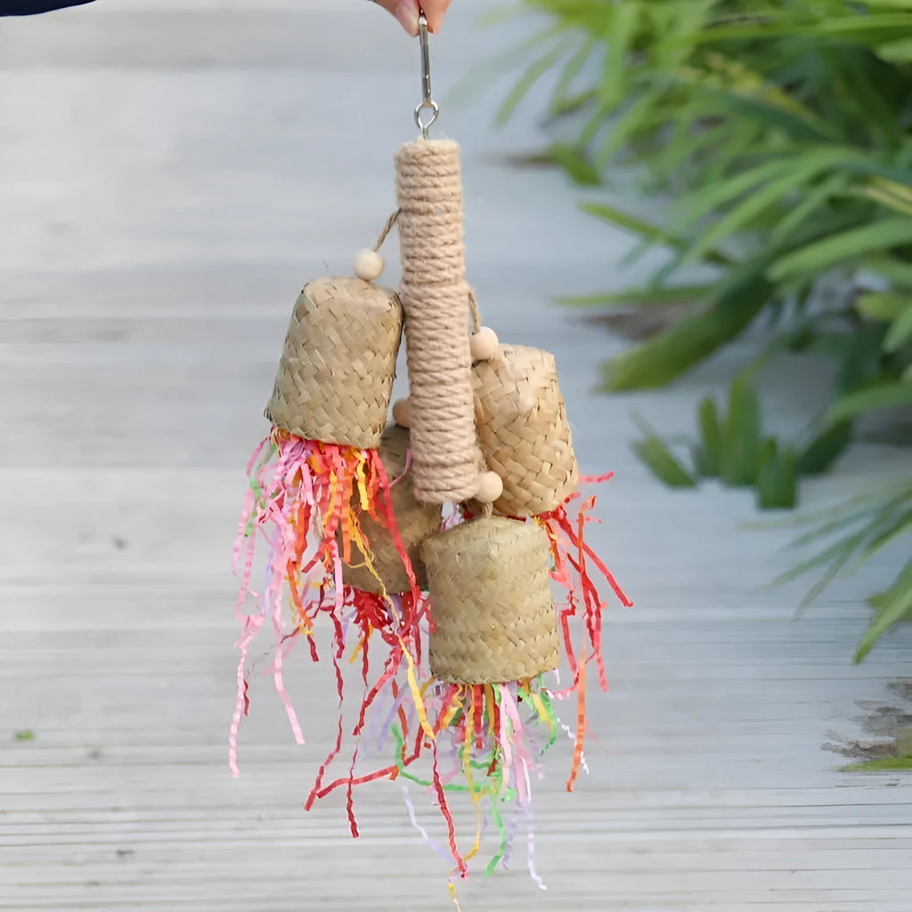 Wood and sisal rope parrot toy with colourful shredded paper strands for foraging.