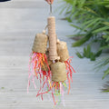 Wood and sisal rope parrot toy with colourful shredded paper strands for foraging.