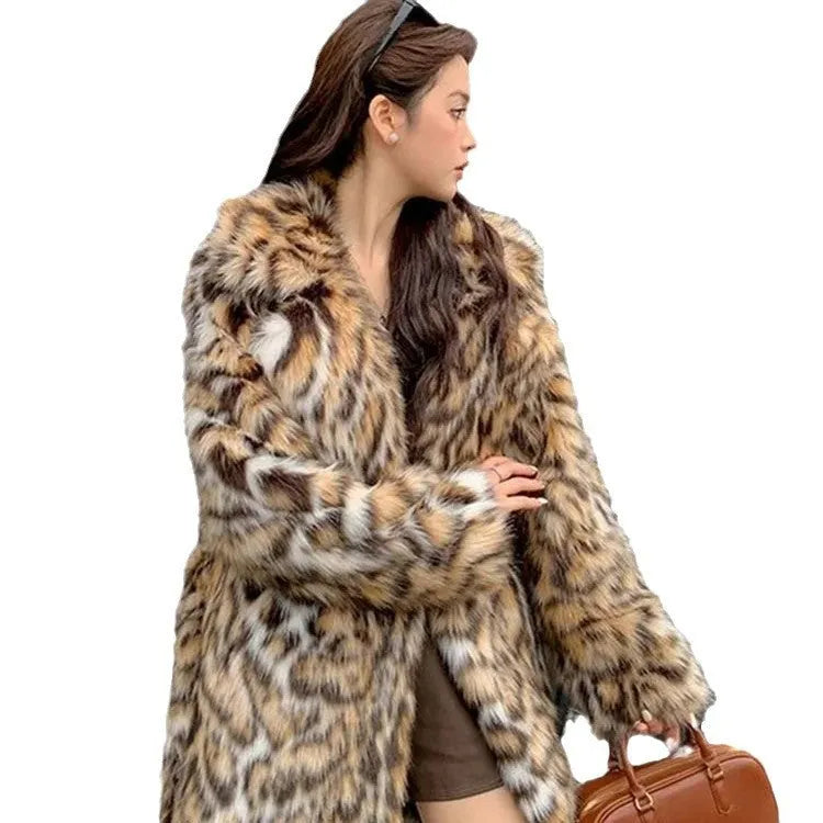 Women's grey faux fur mid-length winter coat with a fur collar and pockets on a model.