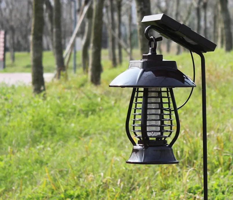 White and purple solar-powered electronic mosquito lamp for outdoor garden use.