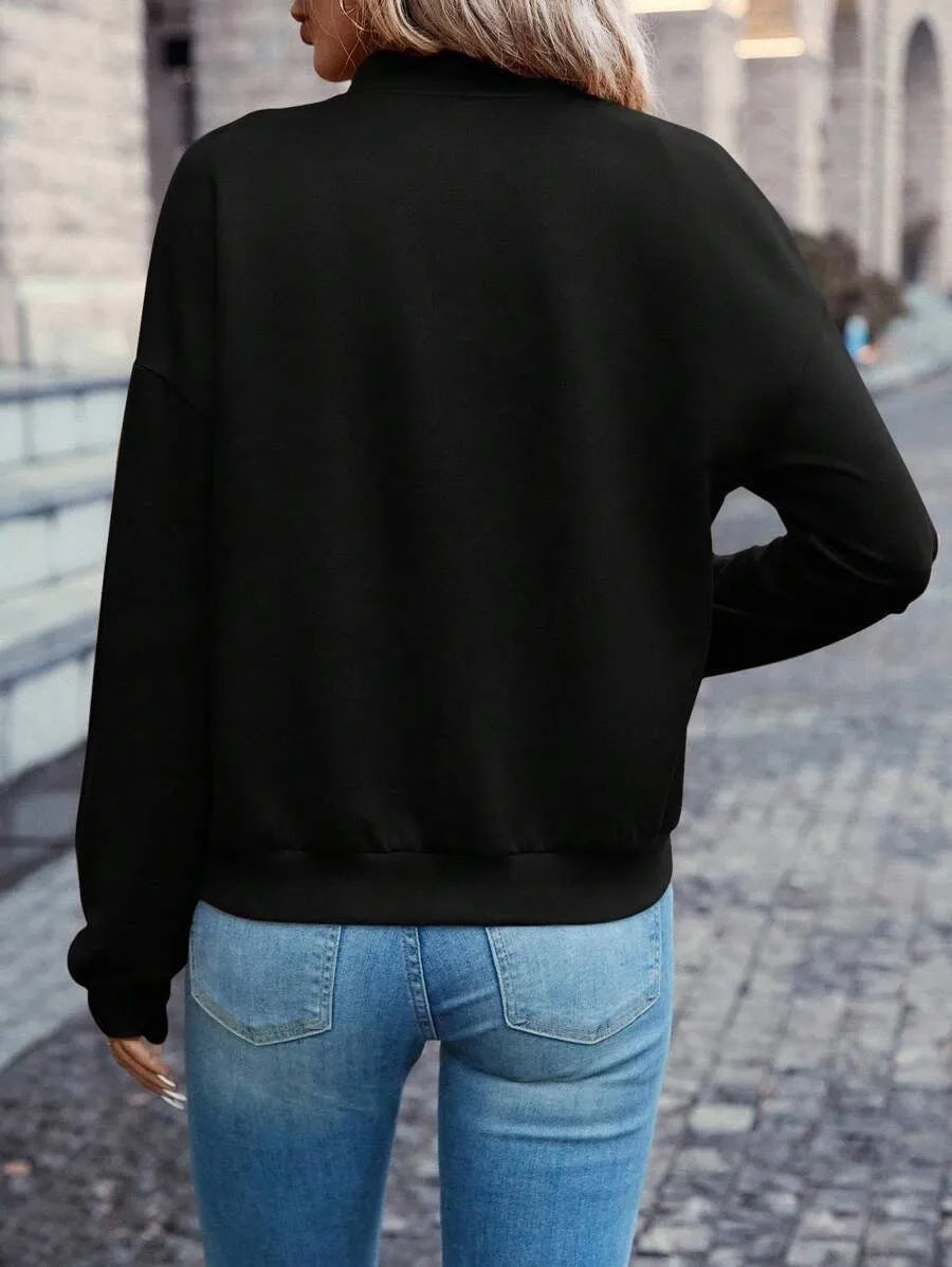 Black women's zip-front casual jacket with long sleeves on a hanger.