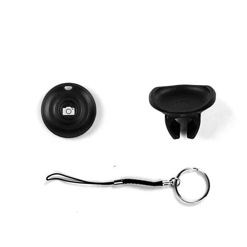 Black Bluetooth remote shutter release for smartphone camera on a white background.