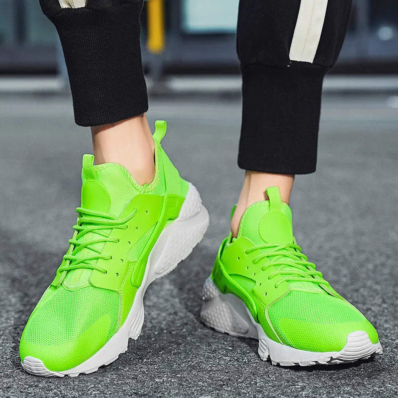 Men's green low top casual mesh shoes with cross shoulder straps and flat sole.