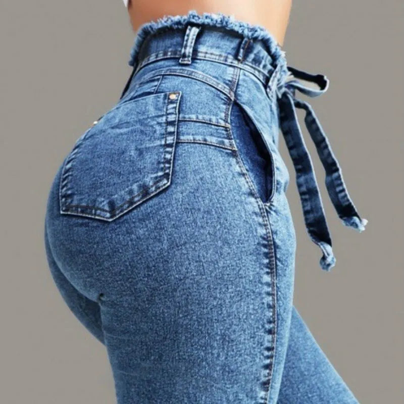 Women's fringed jeans in distressed Cowboy denim with frayed hem detailing in grey, dark blue, or light blue