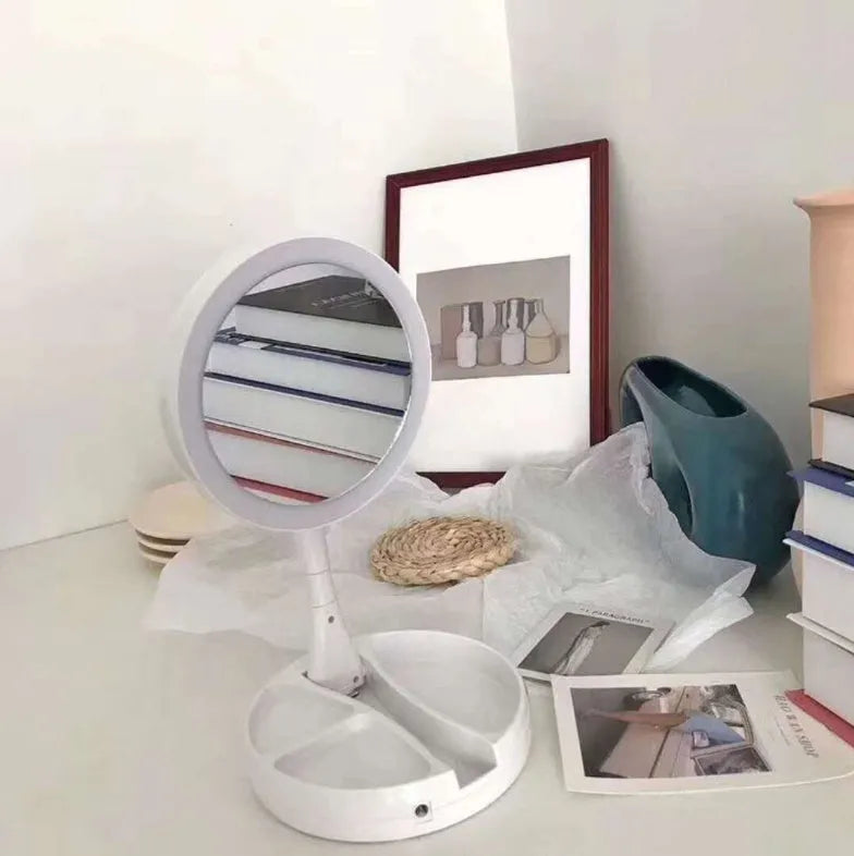 White acrylic frame double-sided LED vanity mirror folded with storage shelf visible