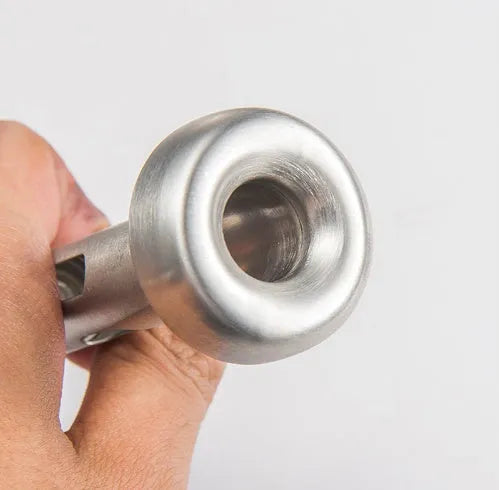 Silver stainless steel wine cooling rod with pourer next to a red wine bottle