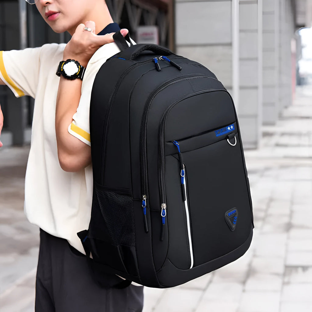 Men's Oxford cloth schoolbag in red with letter pattern, showing air pillow belt and large main compartment.