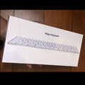 White Apple Bluetooth keyboard with ultra-thin metal design and multimedia function keys