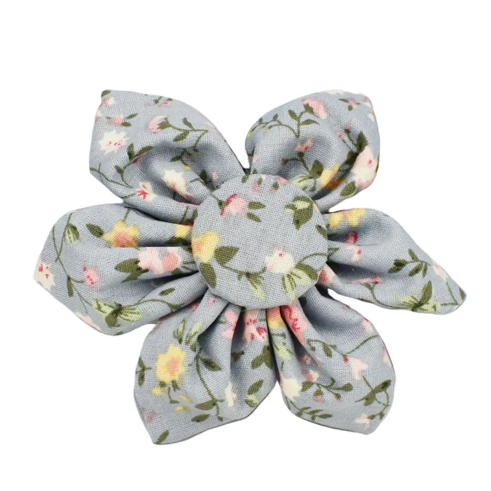 Blue floral patterned fabric bow attached to a decorative dog collar for pets