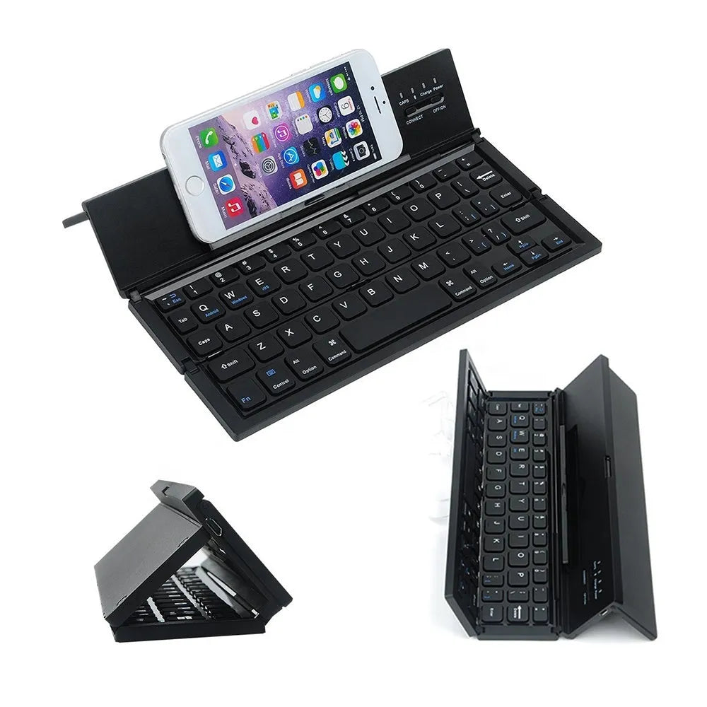 Black folding Bluetooth keyboard with aluminium bottom next to tablet